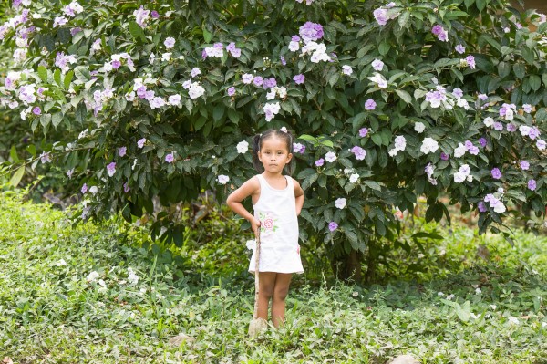 Girl besides flowers, Environmental tax to maintain forests in Costa Rica - If Not Us Then Who?