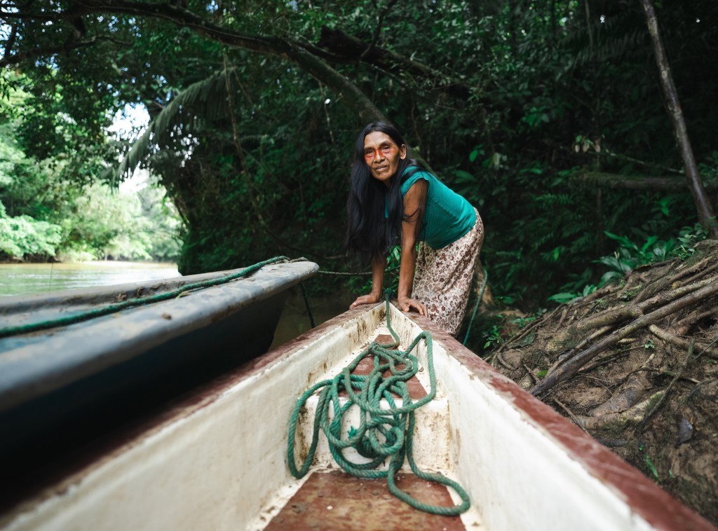 Indigenous woman in a canoe in a amazonian river