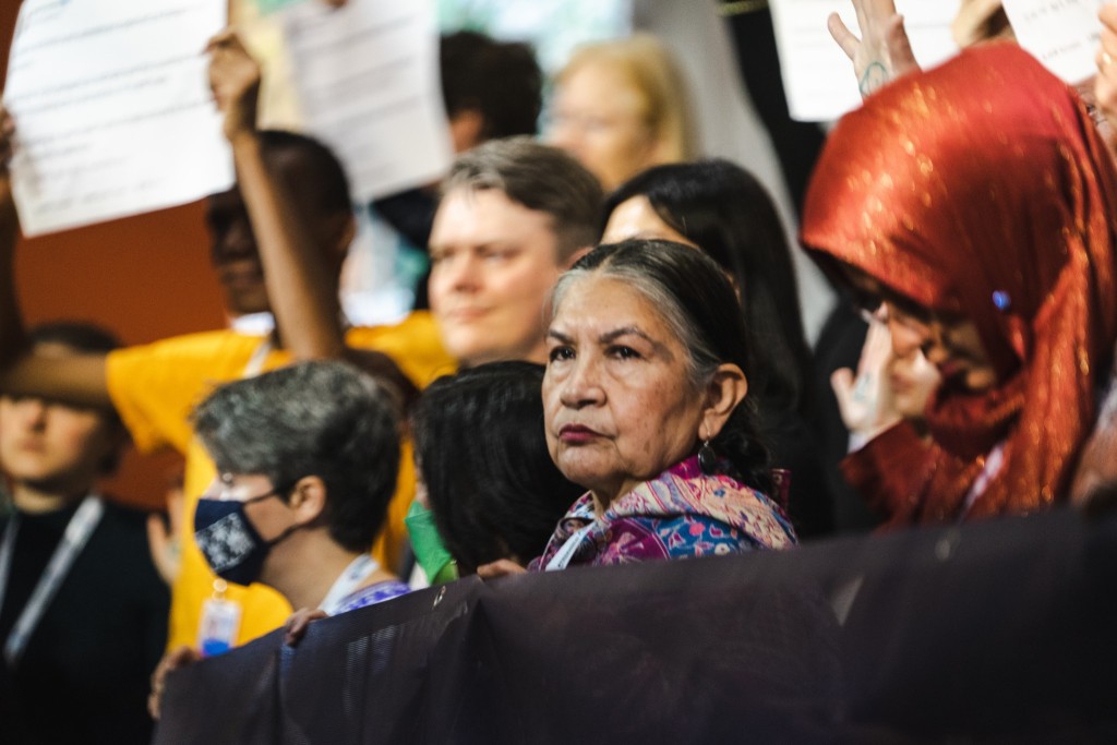 One lady standing in a middle of a crowd