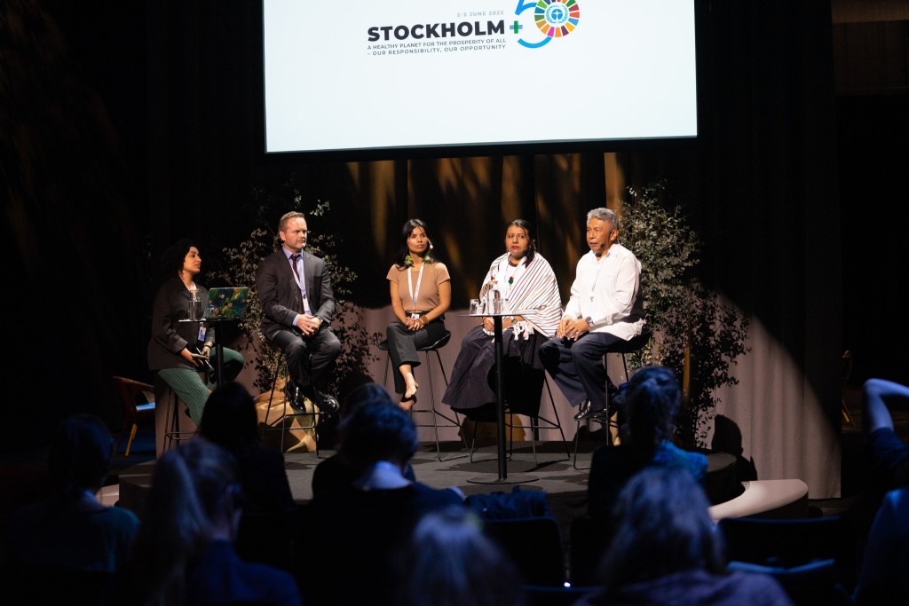 Five people standing in a stage during an event