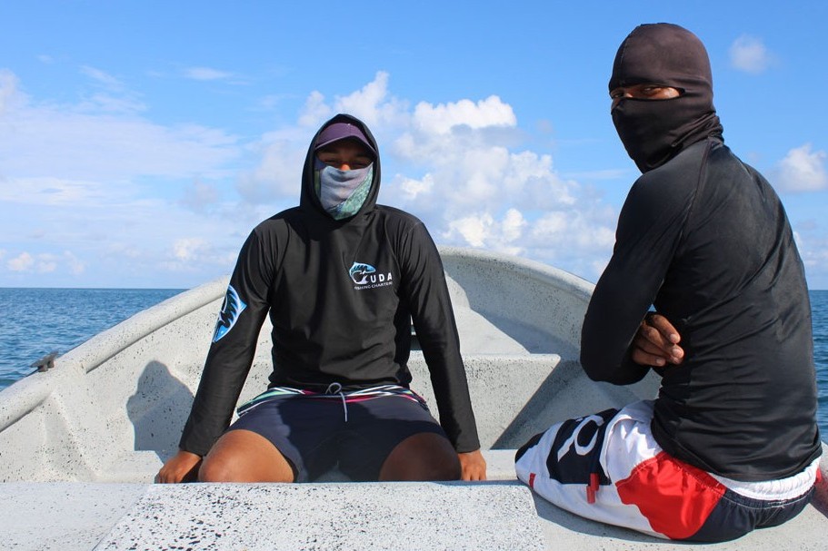two fishermen on a boat in the ocean